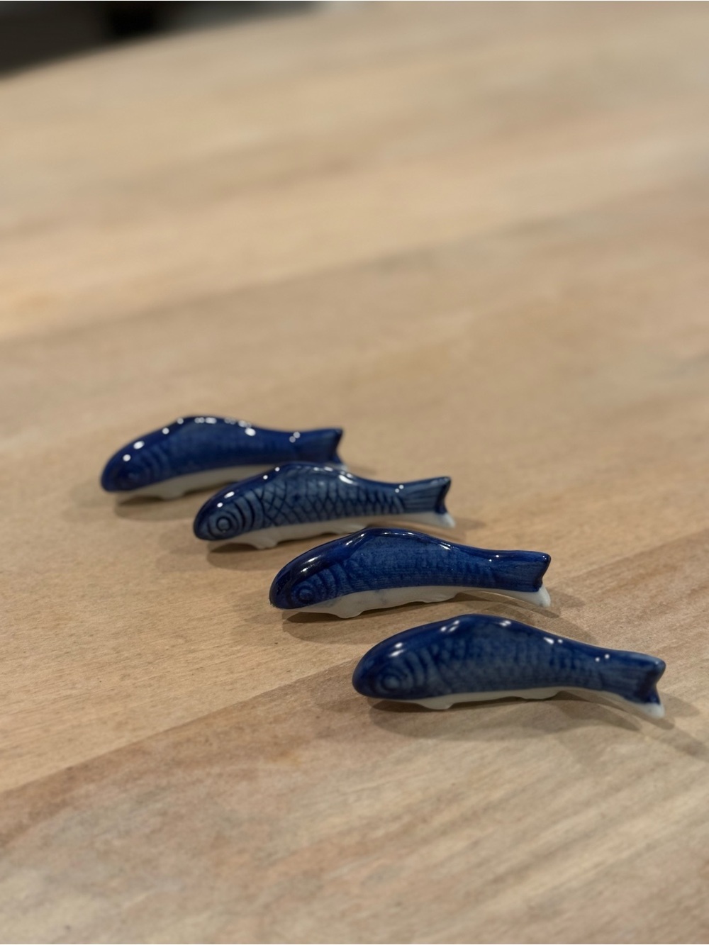 Set of four vintage blue and white ceramic fish-shaped chopstick rests